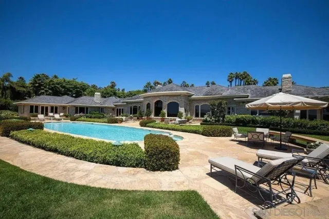 a front view of a house with a garden and plants