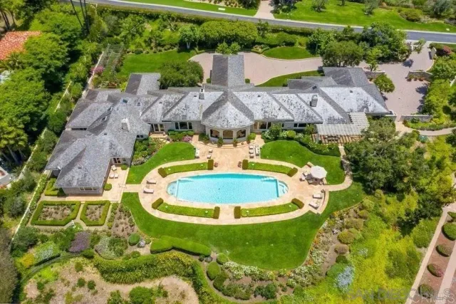 an aerial view of residential house with outdoor space and pool