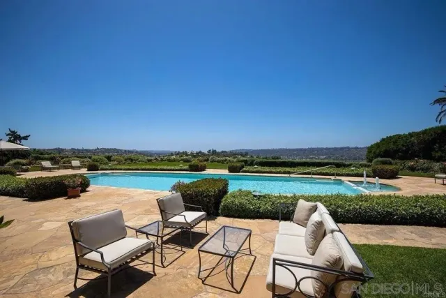 a view of swimming pool with outdoor seating