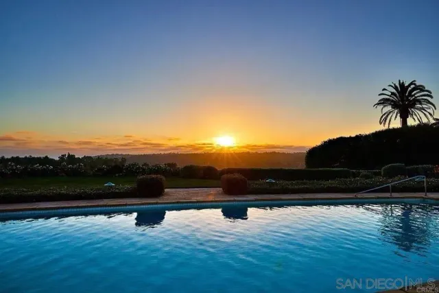 a view of a lake with couches in the backyard