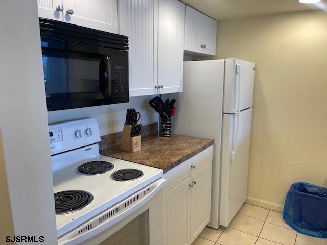 4500 West Brigantine Avenue, Unit 2322 Brigantine, NJ 08203 - Photo 2 of 16 a kitchen with a refrigerator and a stove top oven