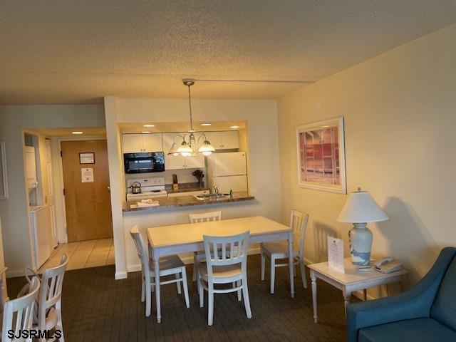 4500 West Brigantine Avenue, Unit 2322 Brigantine, NJ 08203 - Photo 5 of 16 a dining room with furniture and wooden floor