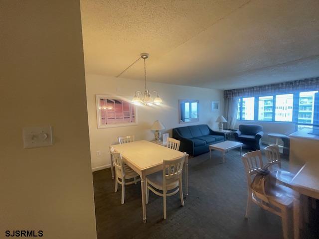 4500 West Brigantine Avenue, Unit 2322 Brigantine, NJ 08203 - Photo 6 of 16 a living room with lots of furniture and a chandelier
