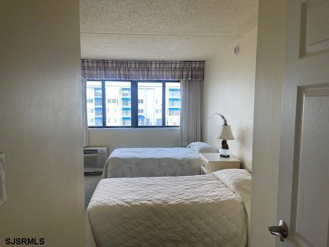 4500 West Brigantine Avenue, Unit 2322 Brigantine, NJ 08203 - Photo 8 of 16 a bedroom with a bed and window