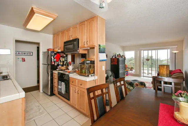 a kitchen with a sink a stove and cabinets