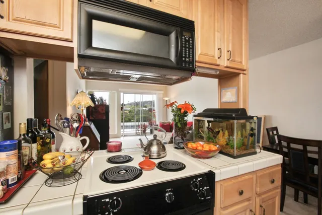 a stove top oven sitting inside of a kitchen