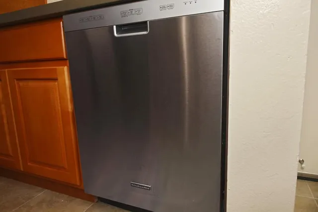 a bedroom that has two beds and a desk in it