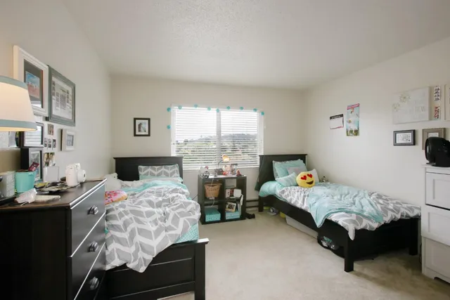 a bedroom with bed and a window