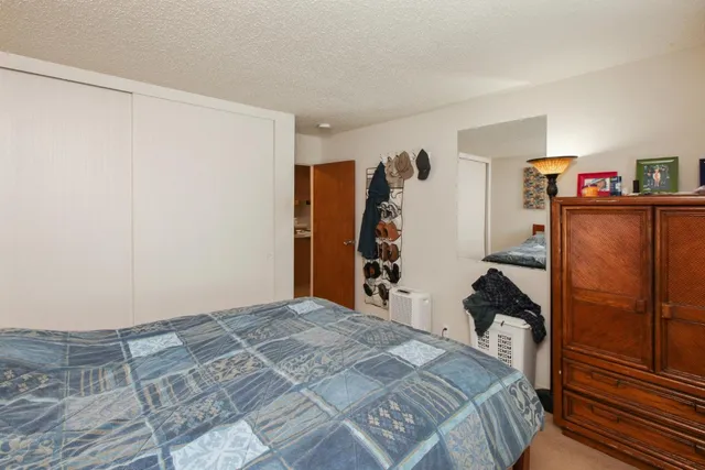 a room with furniture a air conditioner vent and a window