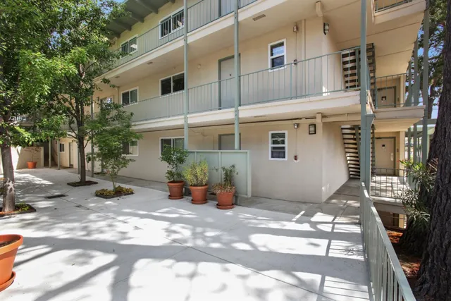 a view of a patio with table and chairs and potted plants