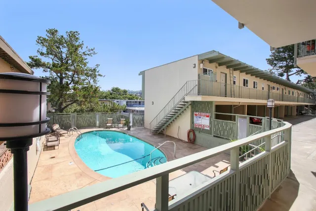 a view of a house with swimming pool and sitting area