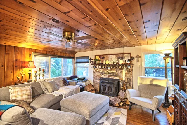 a living room with furniture a fireplace and a table