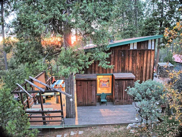 a backyard of a house with garden and outdoor seating