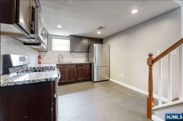 407 Hudson Street, Unit 1 Hackensack, NJ 07601 - Photo 3 of 8 a kitchen with refrigerator and cabinets