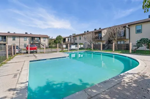a swimming pool with outdoor seating and yard