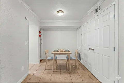 a dining room with furniture and wooden floor