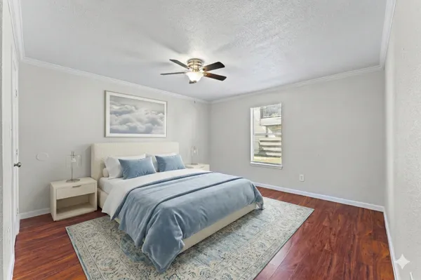 a spacious bedroom with a large bed and a chandelier
