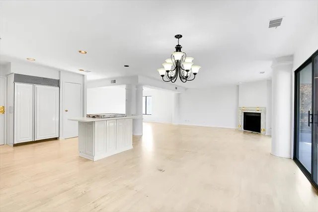 a view of a kitchen with a sink and chandelier