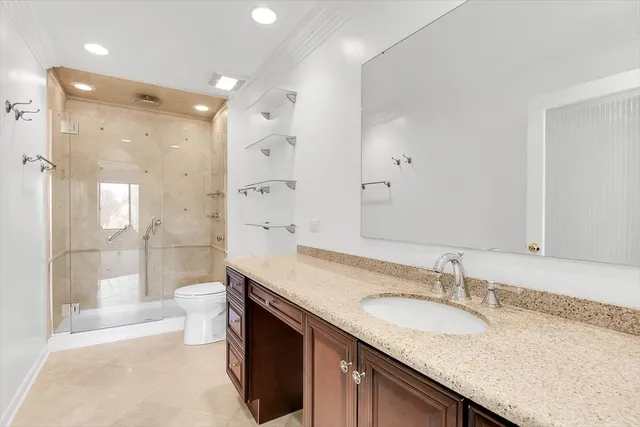 a bathroom with a granite countertop sink mirror and a shower