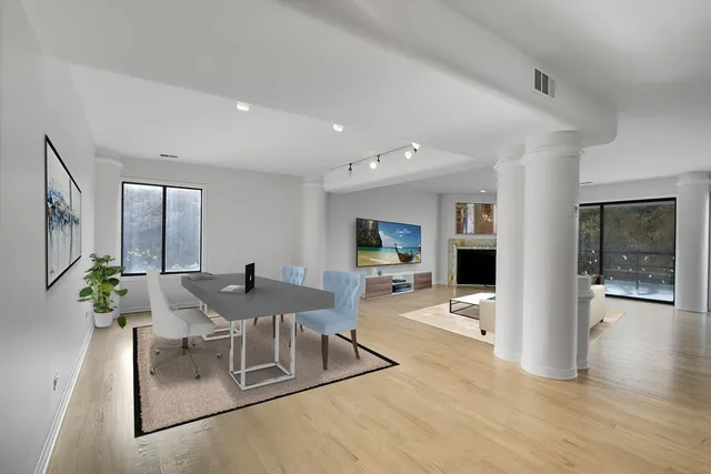 a view of a dining room with furniture and wooden floor