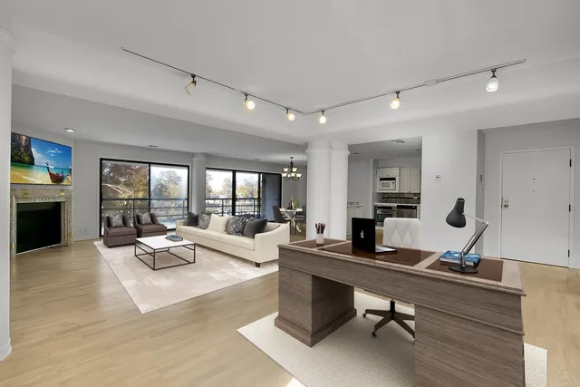 a living room with furniture floor to ceiling window and couch