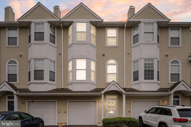a front view of a residential apartment building with a yard