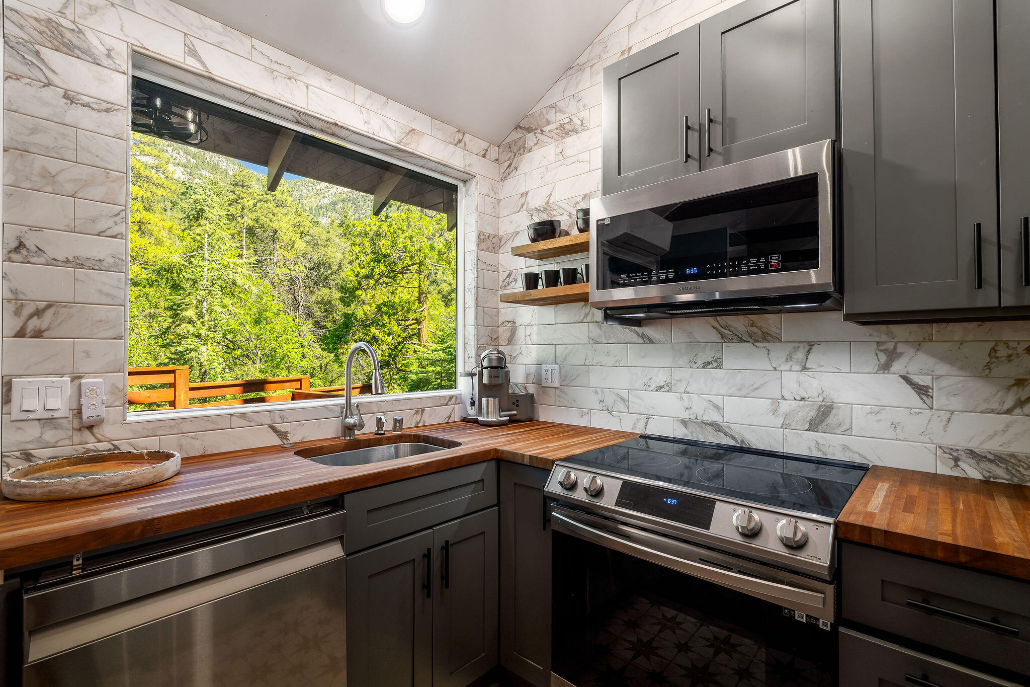 55599 Encino Road Idyllwild, CA 92549 - Photo 12 of 66 a kitchen with stainless steel appliances a stove sink and microwave