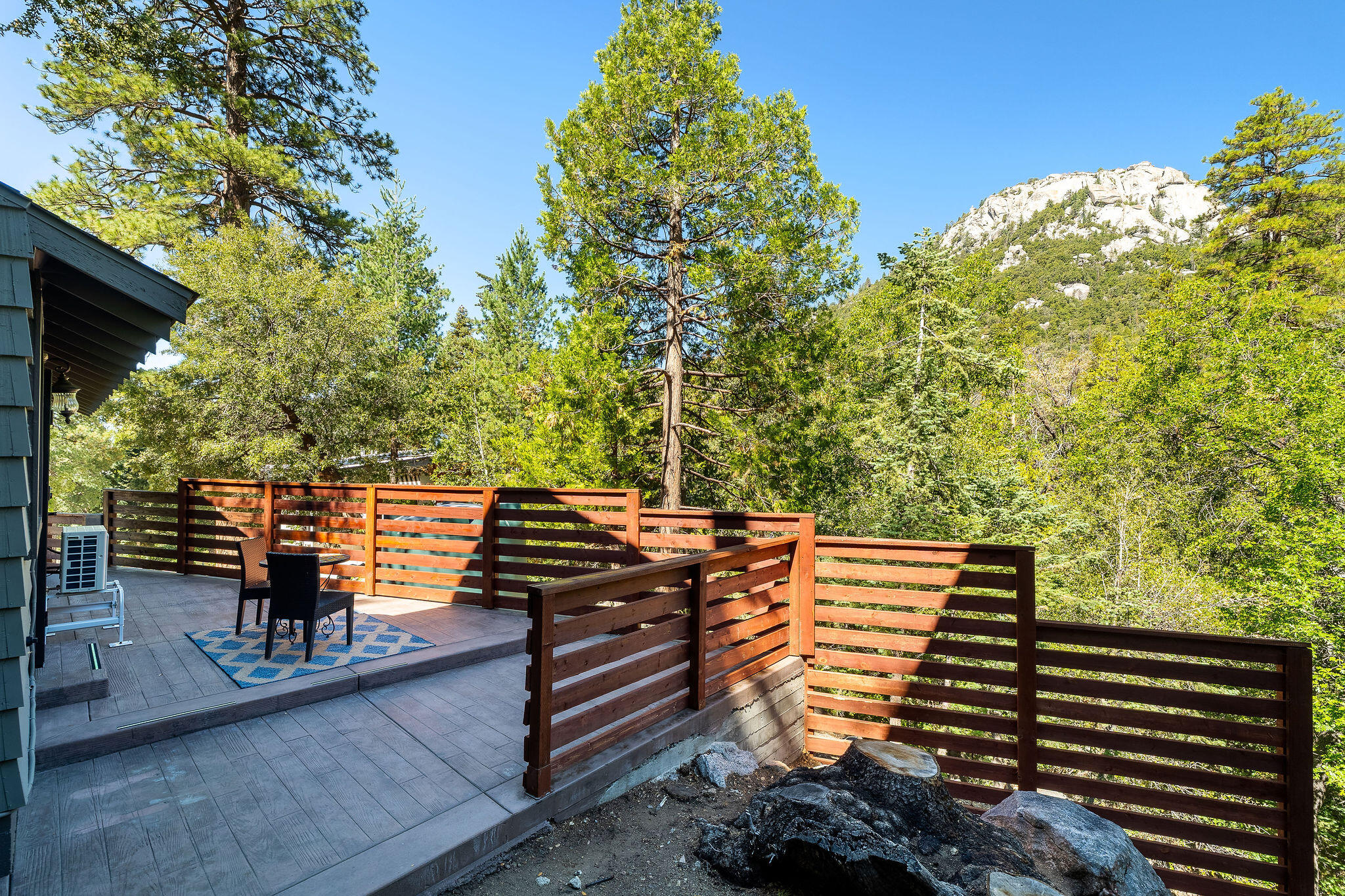 55599 Encino Road Idyllwild, CA 92549 - Photo 14 of 66 a view of a balcony with chairs and wooden fence