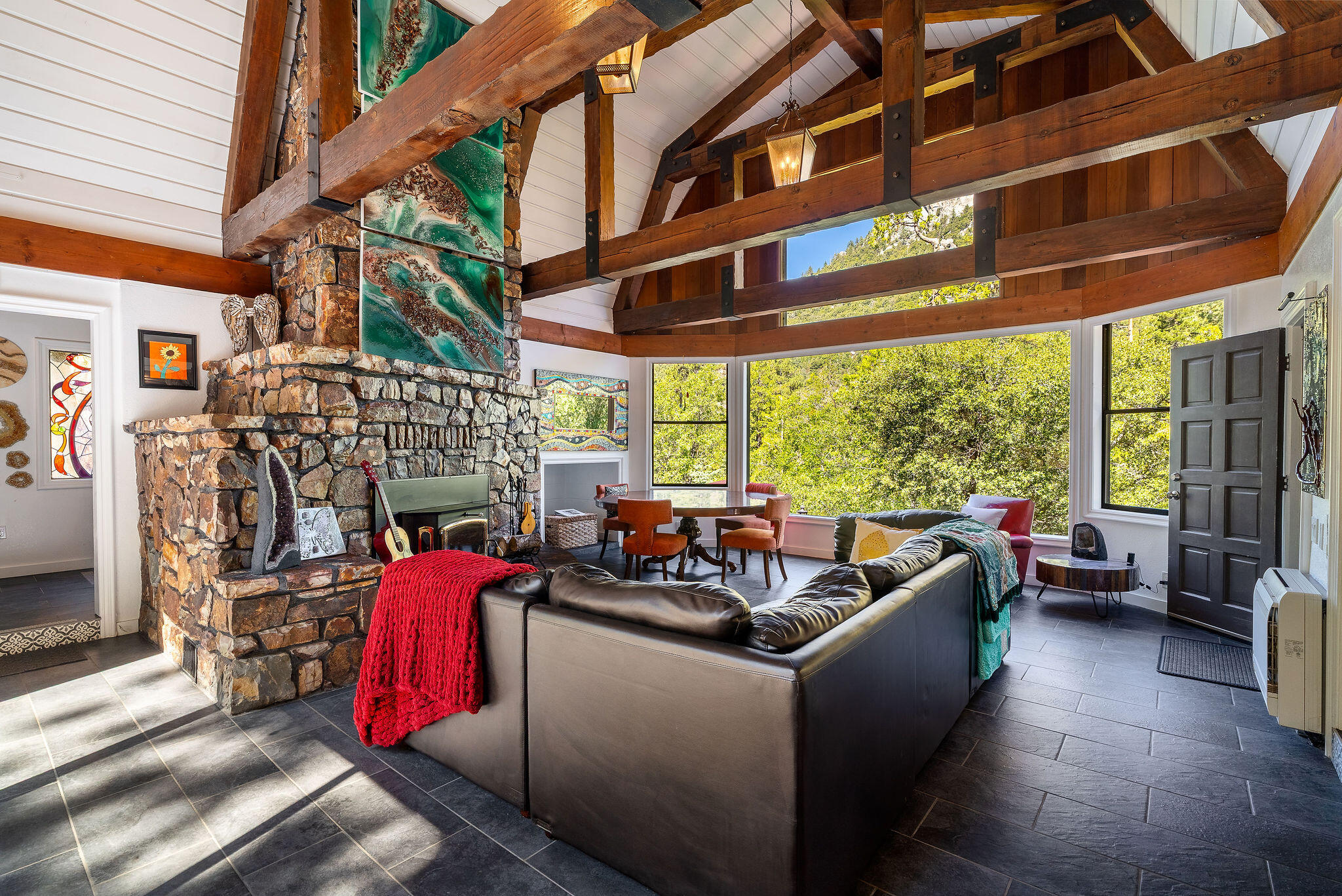 55599 Encino Road Idyllwild, CA 92549 - Photo 19 of 66 a living room with patio furniture and a fireplace