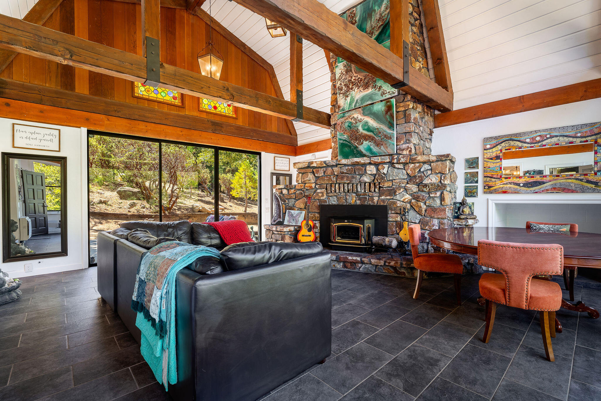 55599 Encino Road Idyllwild, CA 92549 - Photo 20 of 66 a living room with furniture a fireplace and a large window