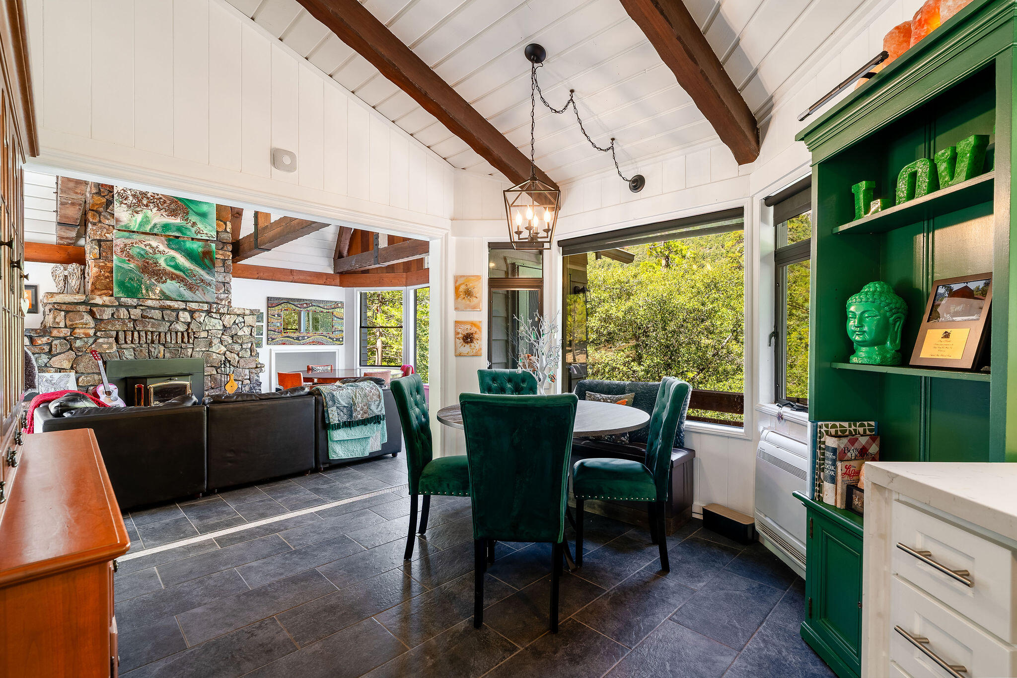55599 Encino Road Idyllwild, CA 92549 - Photo 27 of 66 a dining room with furniture a flat screen tv and a floor to ceiling window