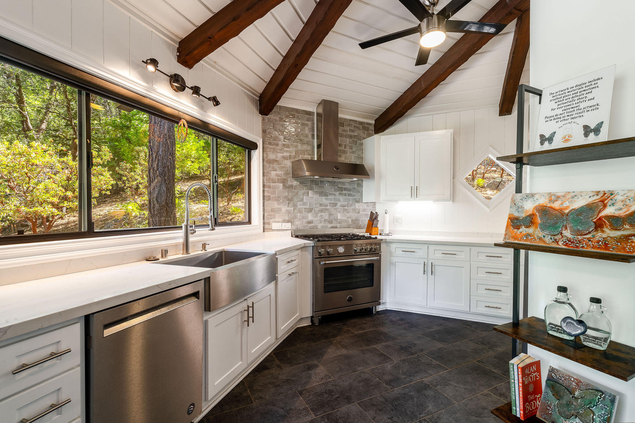55599 Encino Road Idyllwild, CA 92549 - Photo 28 of 66 a kitchen with a sink stove and cabinets