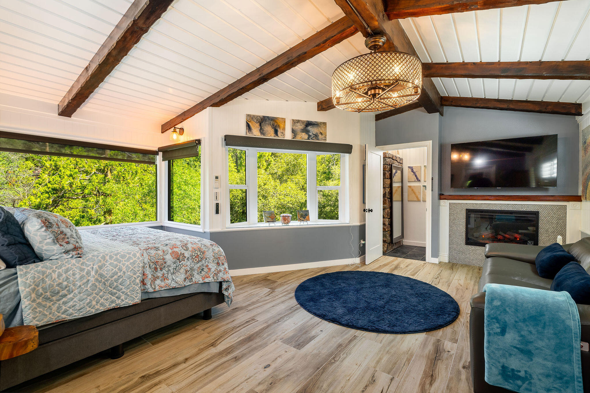 55599 Encino Road Idyllwild, CA 92549 - Photo 34 of 66 a living room with furniture a flat screen tv and a fireplace