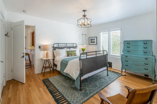 a bed room with a bed and a chandelier