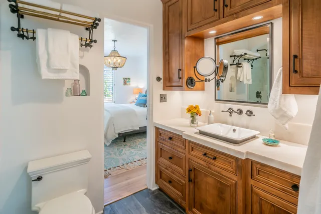 a bathroom with a granite countertop sink a mirror and a shower