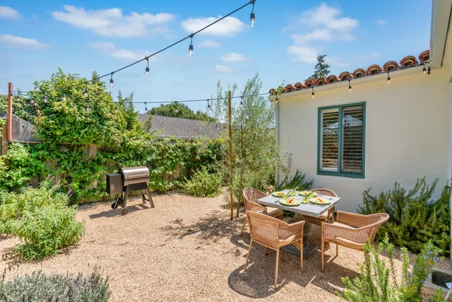 a view of a chairs and table in a patio