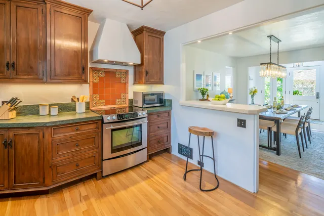 a kitchen with wooden floors and appliances