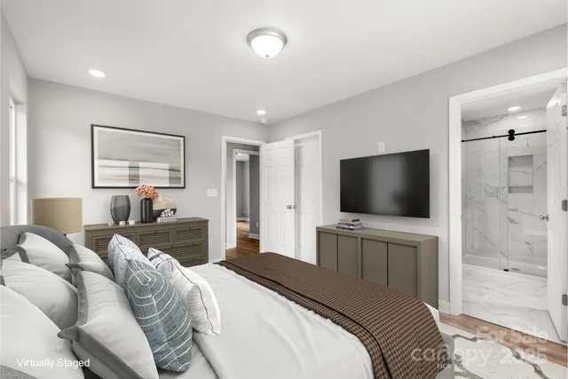 a bedroom with a bed and a flat screen tv