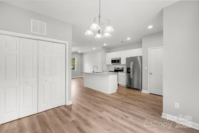a view of a kitchen with a refrigerator and a microwave