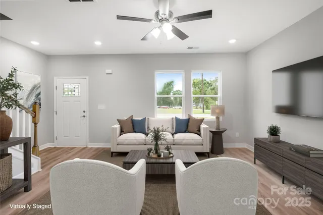 a living room with furniture and a flat screen tv