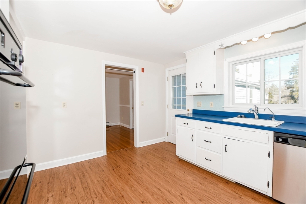 15 Zora Road Marion, MA 02738 - Photo 20 of 42 a kitchen with granite countertop white cabinets and wooden floor