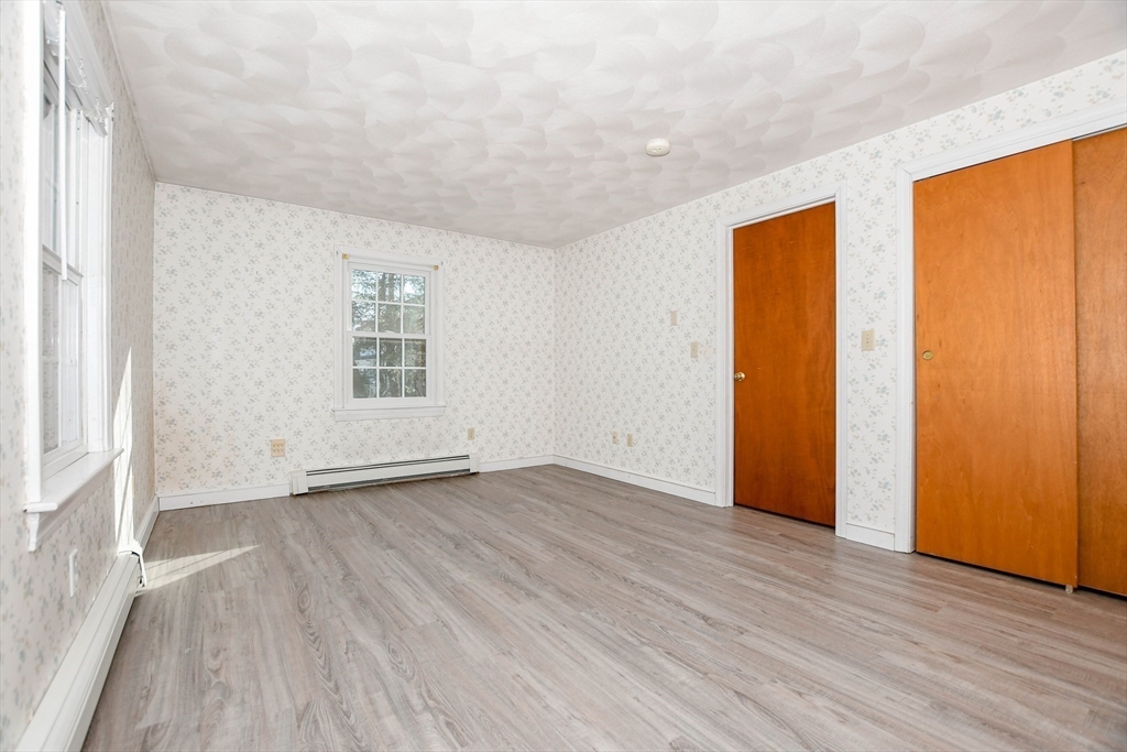 15 Zora Road Marion, MA 02738 - Photo 29 of 42 an empty room with wooden floor and windows