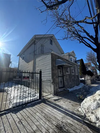 a view of a house with a wooden fence