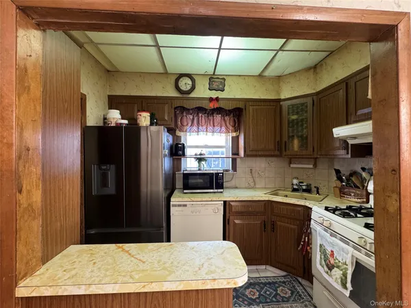 a kitchen with stainless steel appliances kitchen island granite countertop a refrigerator and a stove
