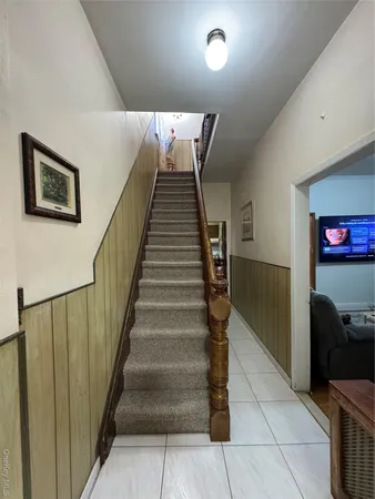 a bedroom with a bed and a dresser next to a window