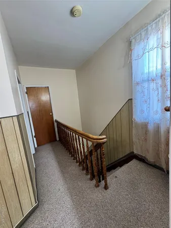 a bedroom with a bed and a mirror