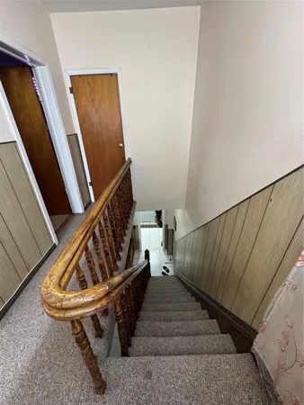 a bedroom with a bed and a kitchen