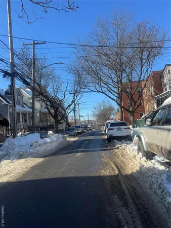 a view of a yard with wooden fence