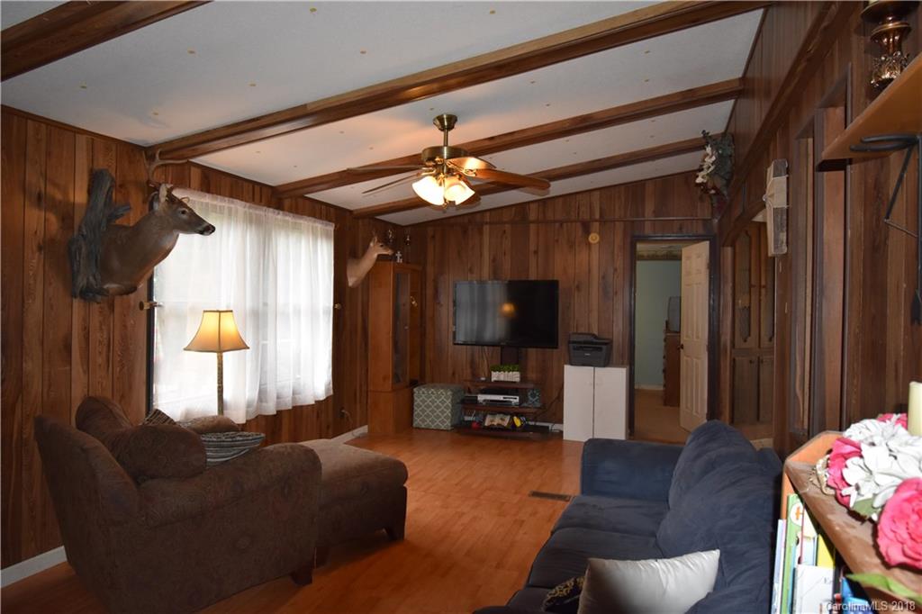 463 Lindsey Loop Road Fletcher, NC 28732 - Photo 11 of 27 a living room with furniture and a flat screen tv