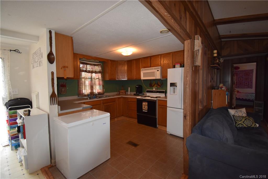 463 Lindsey Loop Road Fletcher, NC 28732 - Photo 15 of 27 a kitchen with refrigerator and cabinets